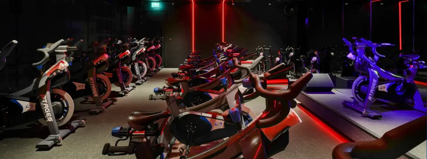 Cycle studio with rows of indoor bikes