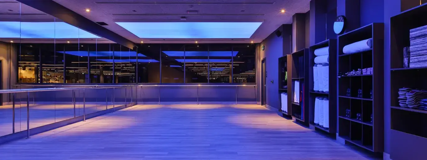 Bright mind-body studio with mats and wooden floor